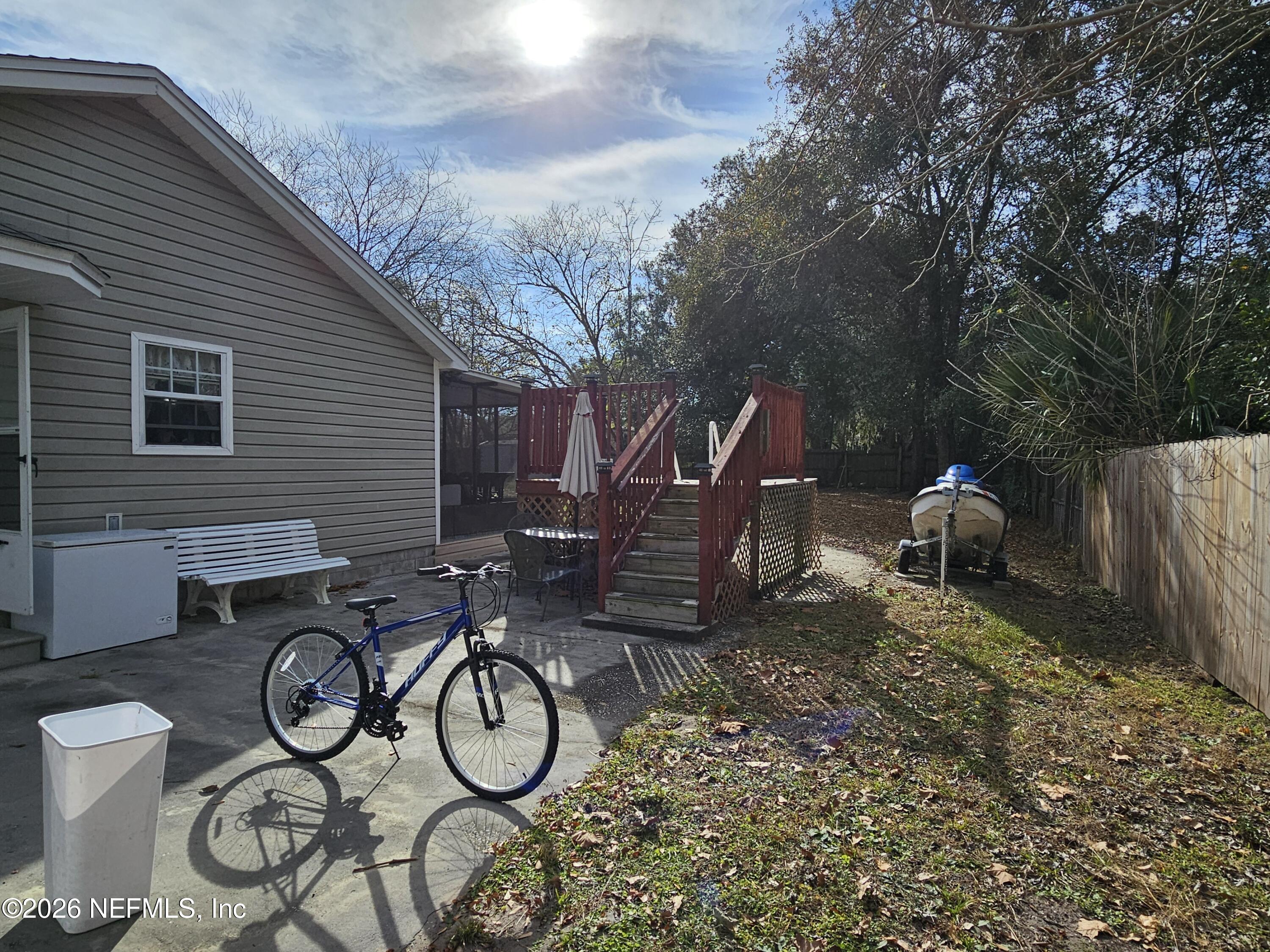 8450 Noroad Jacksonville, FL 32210 - Photo 13 of 14 a view of trees and patio with wooden fence