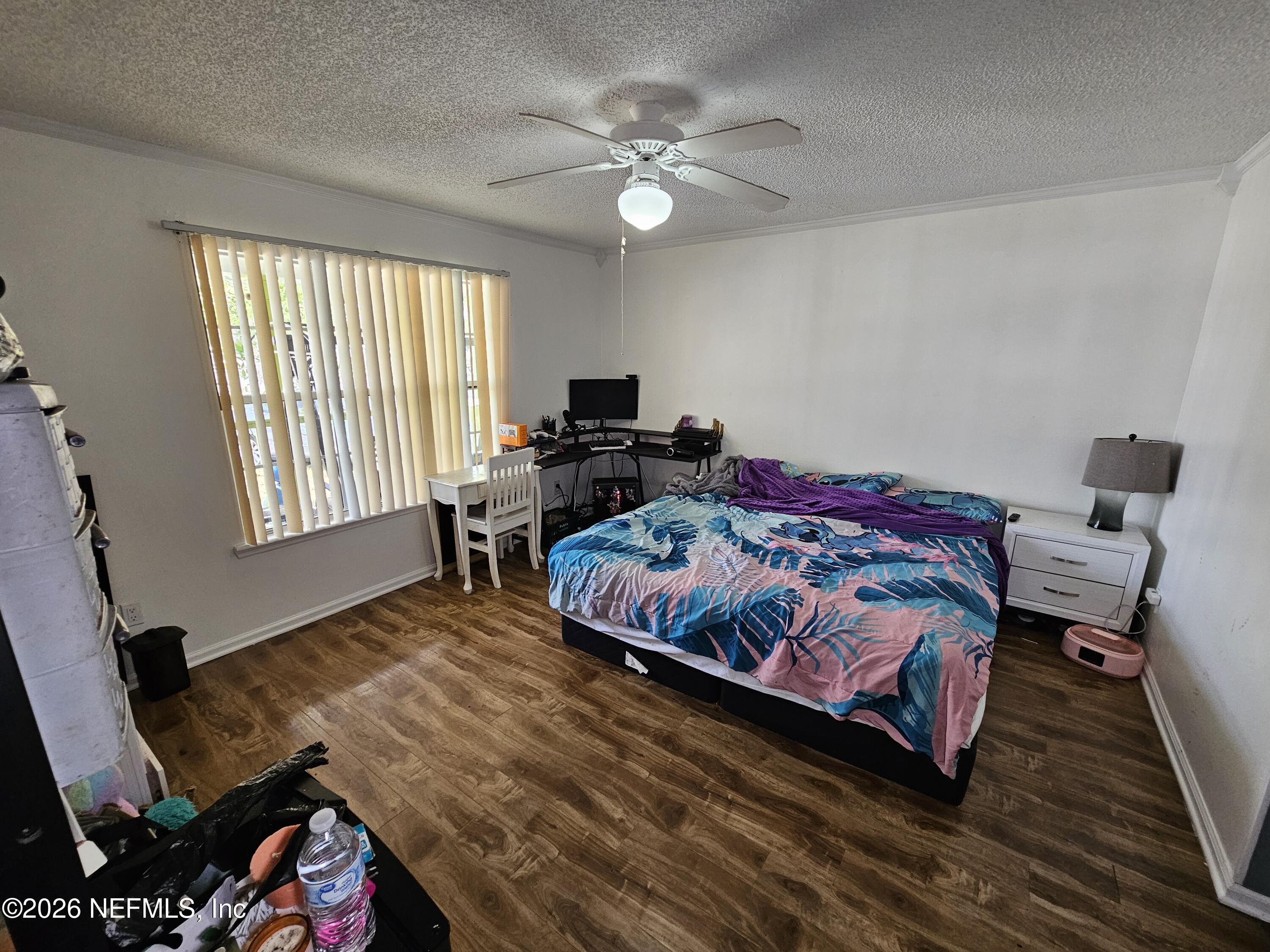 8450 Noroad Jacksonville, FL 32210 - Photo 4 of 14 a bedroom with a bed and a chandelier