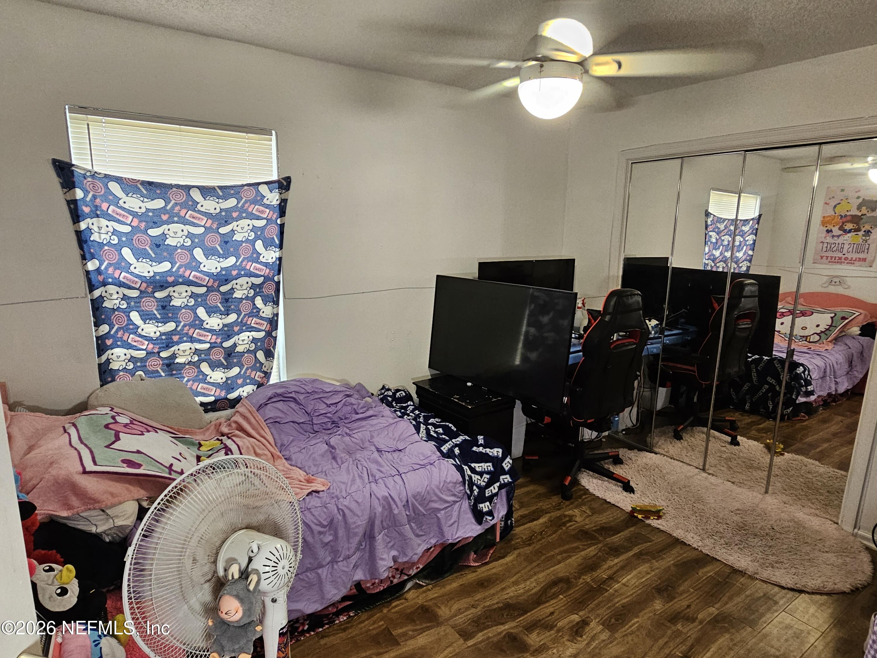 8450 Noroad Jacksonville, FL 32210 - Photo 7 of 14 a bedroom with a bed and a chandelier