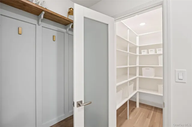 a view of empty room with wooden floor