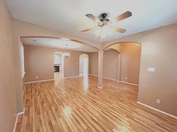 a view of an empty room and wooden floor