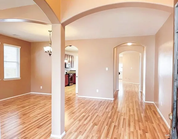 a view of an empty room and wooden floor
