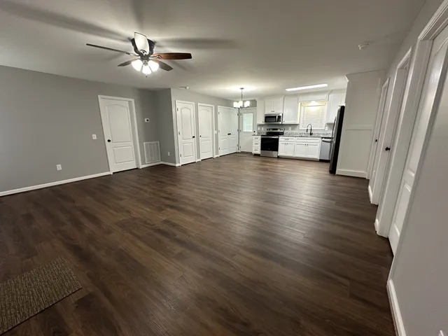 a view of a kitchen with a sink and a stove top oven
