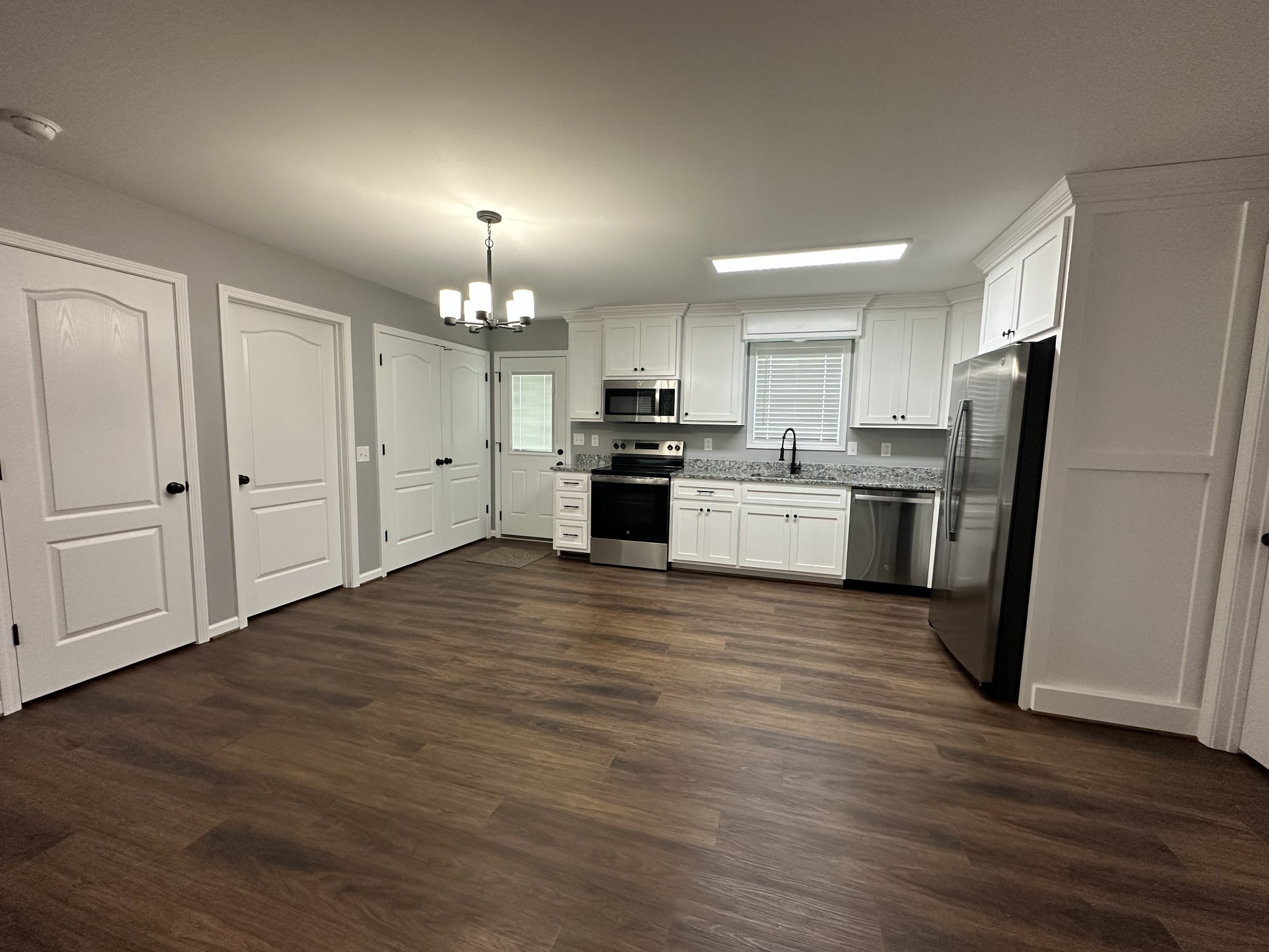 24 Henkle Lane Loretto, TN 38469 - Photo 15 of 21 a kitchen with granite countertop a refrigerator and a stove top oven