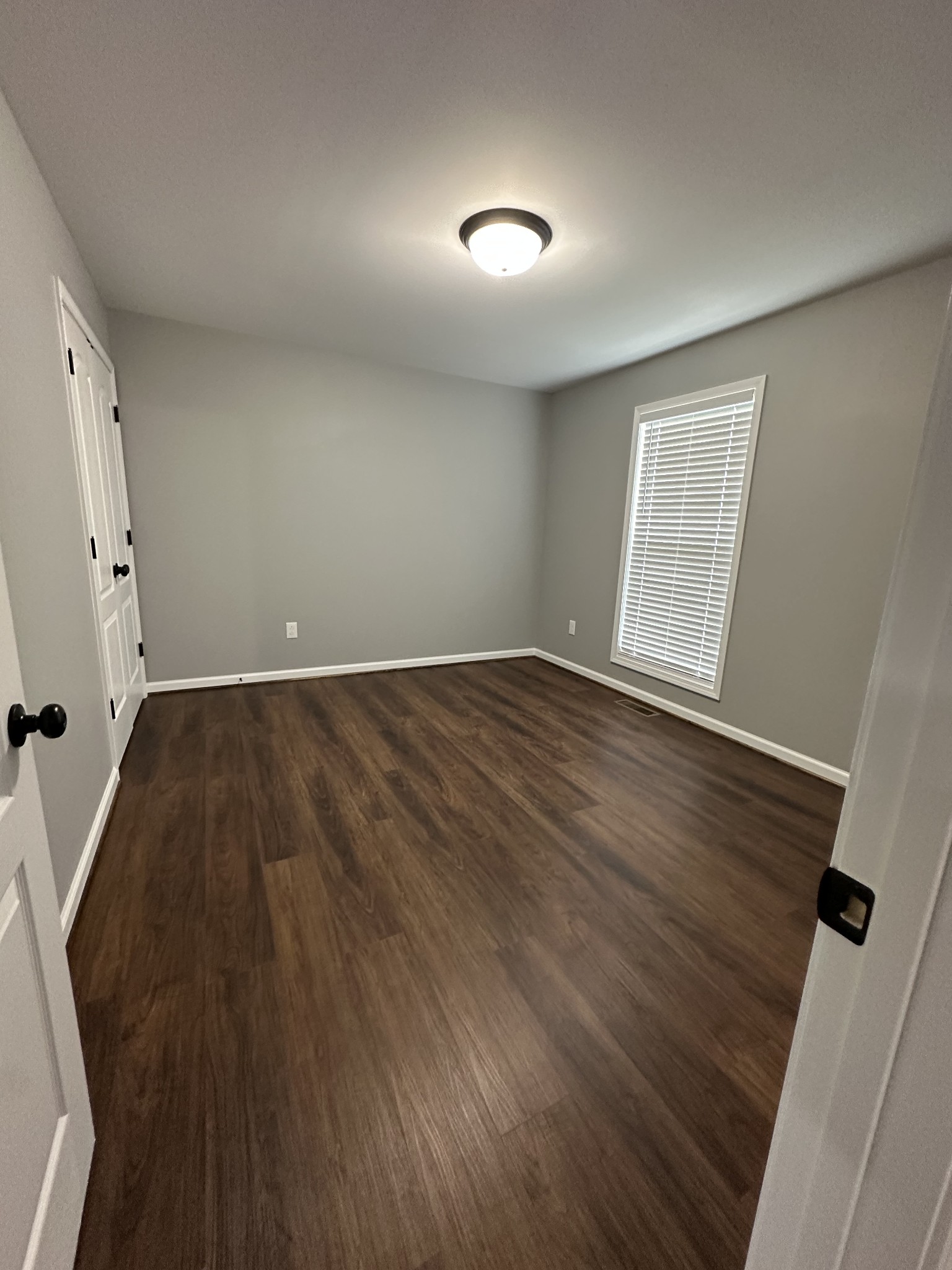 24 Henkle Lane Loretto, TN 38469 - Photo 18 of 21 an empty room with wooden floor and windows