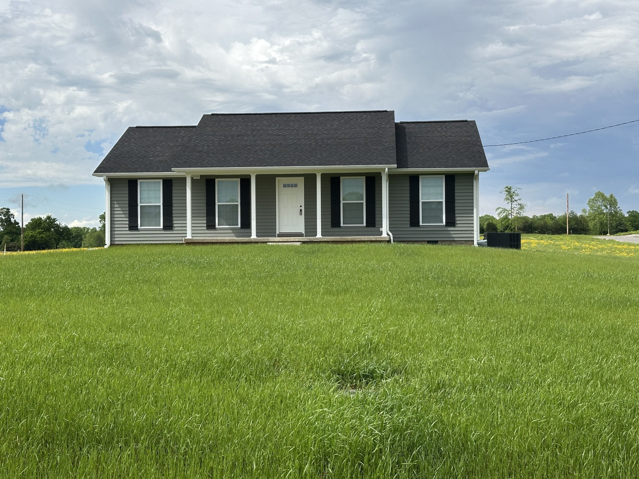 24 Henkle Lane Loretto, TN 38469 - Photo 2 of 21 a view of a white house with a big yard and large trees