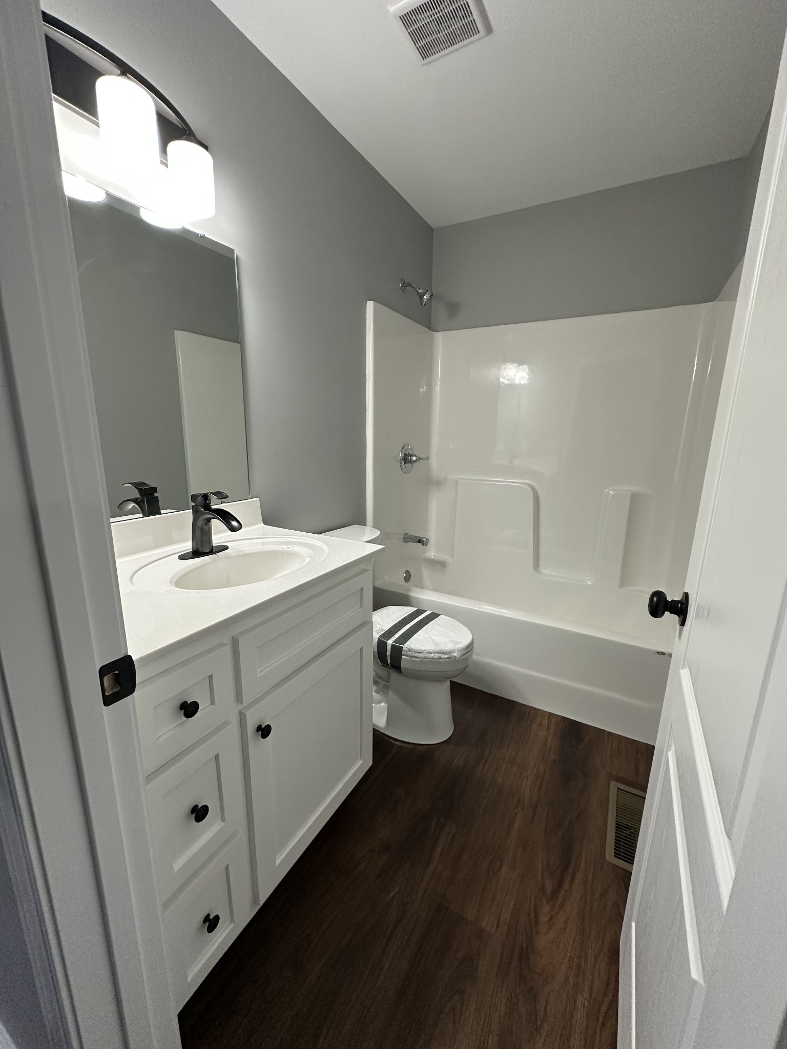 24 Henkle Lane Loretto, TN 38469 - Photo 21 of 21 a bathroom with a double vanity sink a toilet and a mirror