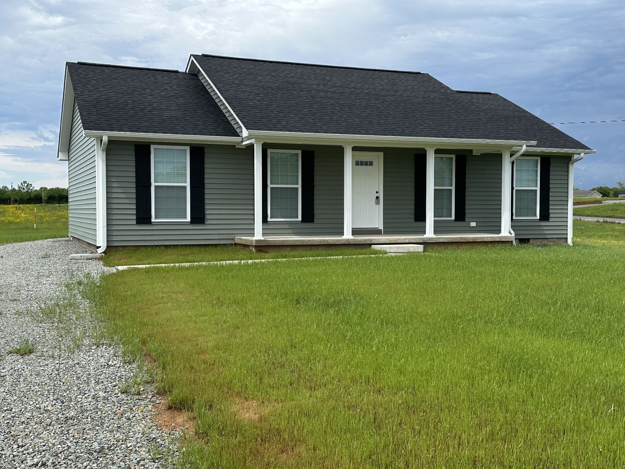 24 Henkle Lane Loretto, TN 38469 - Photo 4 of 21 a front view of a house with a garden