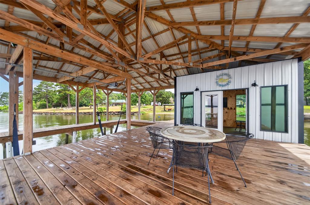 23363 Wateridge Loop Flint, TX 75762 - Photo 11 of 40 a view of a patio with table and chairs and wooden floor