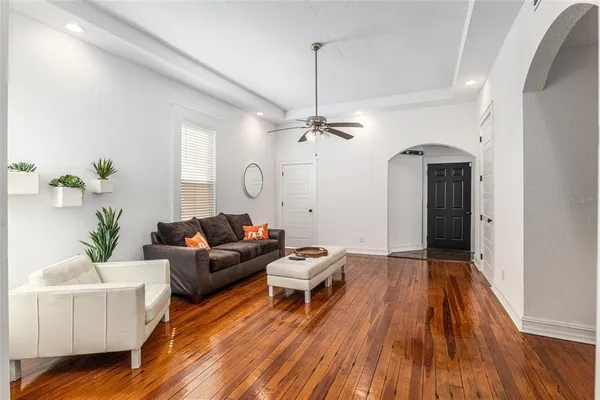 a living room with furniture and wooden floor