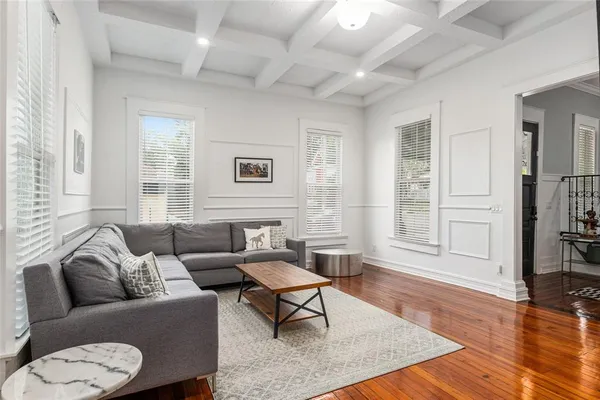 a view of a room with lots of furniture and wooden floor
