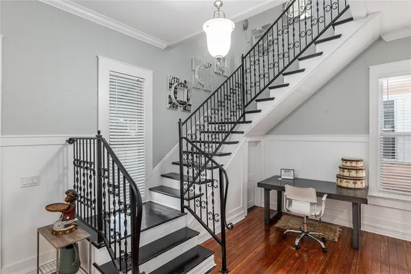 a view of staircase with railing and white walls