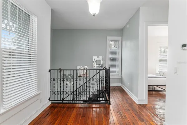 a spacious bedroom with a bed next to a large window with the outer view