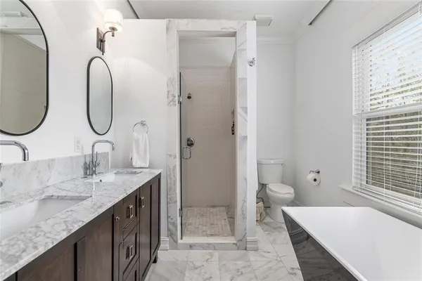 a view of a hallway with wooden floor and door
