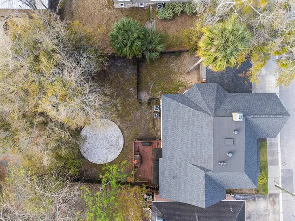 an aerial view of a house with outdoor space and a lake view