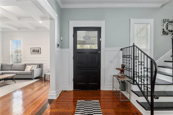 a view of a livingroom with furniture and hardwood floor