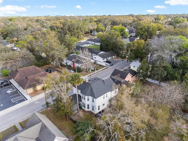 an aerial view of multiple houses with yard