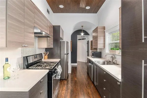 a stove top oven sitting inside of a kitchen