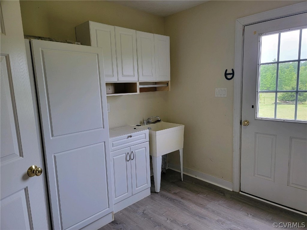 6851 Cox Road Wilsons, VA 23894 - Photo 35 of 50 a room with cabinets and wooden floor