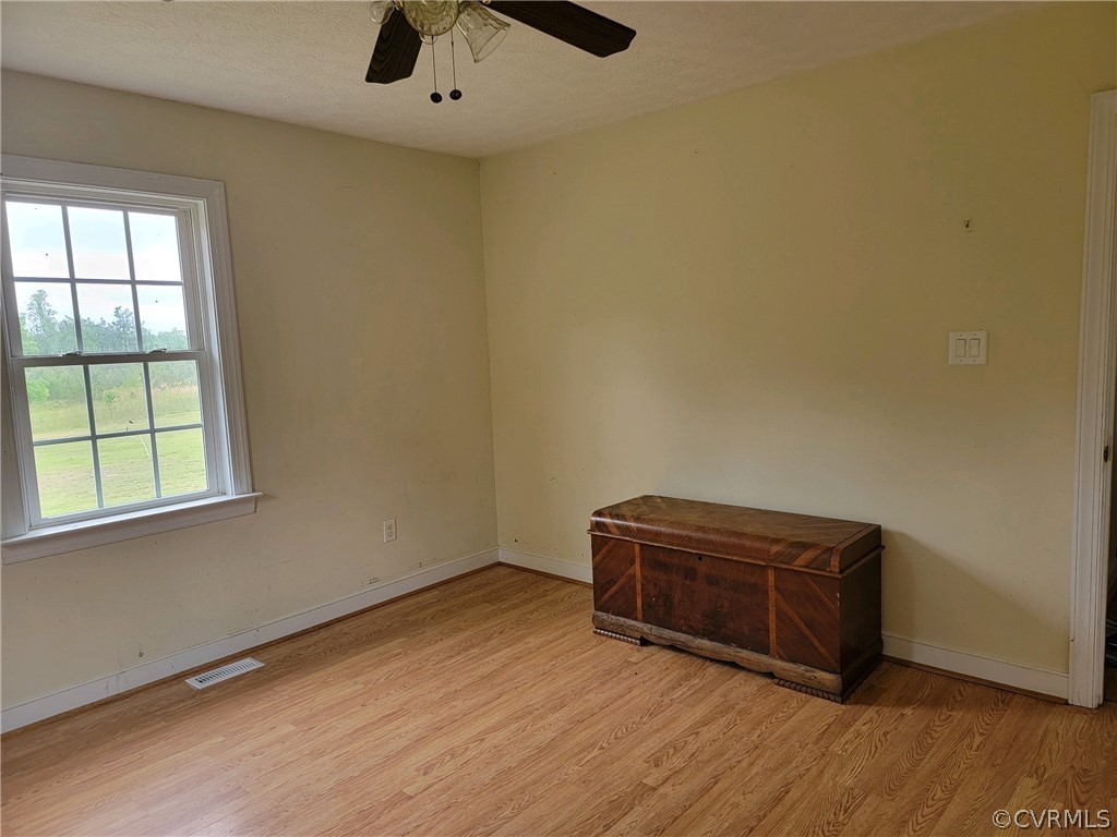 6851 Cox Road Wilsons, VA 23894 - Photo 40 of 50 an empty room with wooden floor and windows