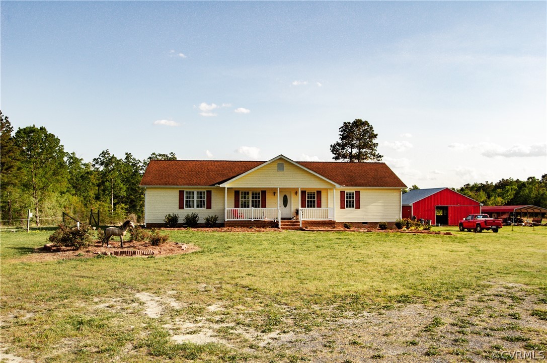 6851 Cox Road Wilsons, VA 23894 - Photo 4 of 50 a white house with a big yard and large trees