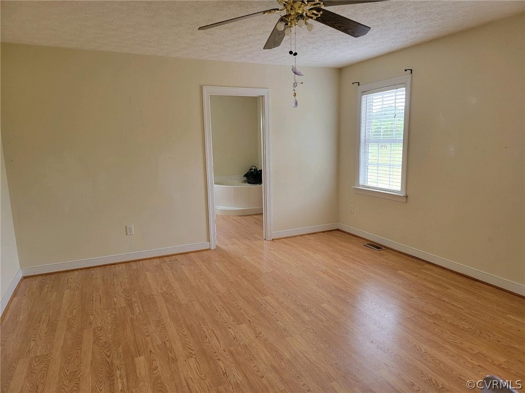 6851 Cox Road Wilsons, VA 23894 - Photo 45 of 50 a view of an empty room with a window and wooden floor