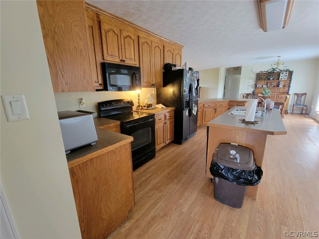 6851 Cox Road Wilsons, VA 23894 - Photo 49 of 50 a kitchen with microwave a stove and refrigerator