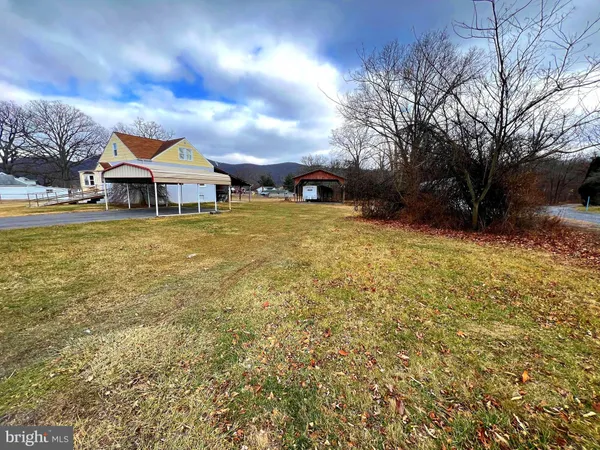 a front view of house with yard and trees