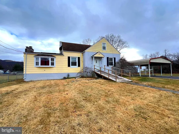 a front view of a house with a yard outdoor seating and garage