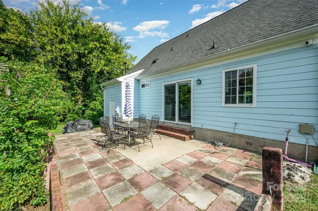 a backyard of a house with outdoor seating