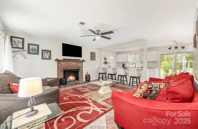 a living room with furniture fireplace and a flat screen tv