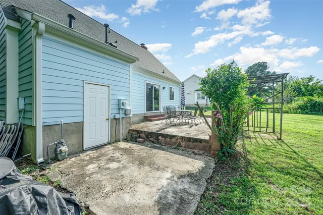 a view of a house with backyard and sitting area
