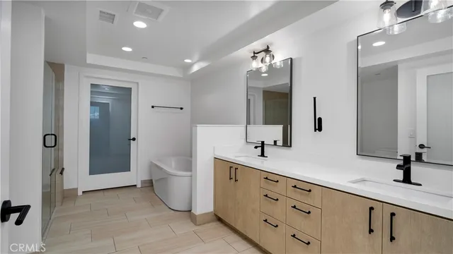 a bathroom with a double vanity sink and a mirror