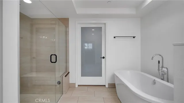 a bathroom with a bathtub and shower