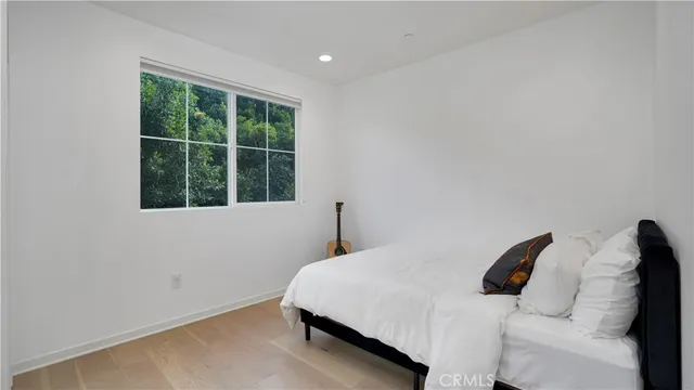 a bedroom with a bed and a window