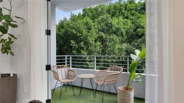 a view of roof deck with chairs and potted plant