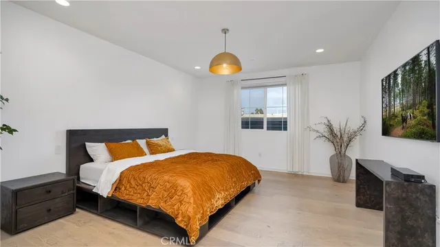 a bedroom with a large bed and a window