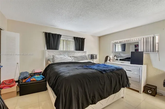 a bedroom with a bed and a tv