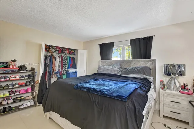 a bedroom with a bed and a tv