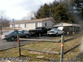 22 Tyler Street Clyde, NC 28721 - Photo 8 of 9 a front view of a house with cars parked