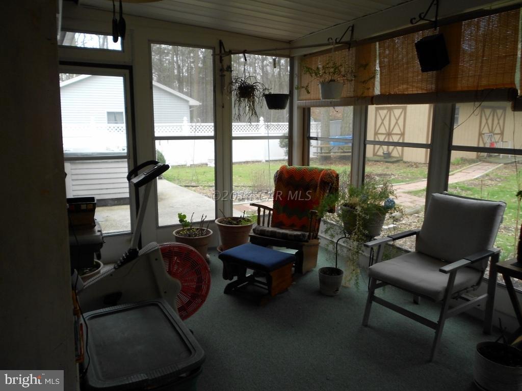 9240 Croppers Island Road Newark, MD 21841 - Photo 13 of 19 a living room with furniture and a floor to ceiling window