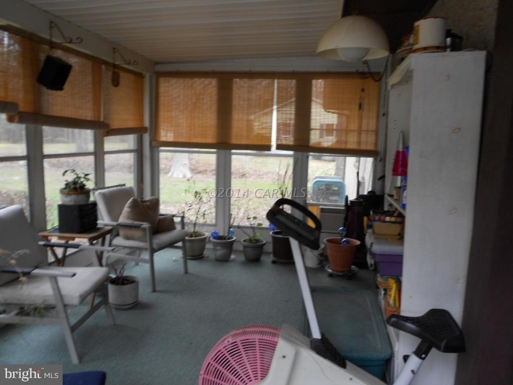 9240 Croppers Island Road Newark, MD 21841 - Photo 14 of 19 a living room with furniture and floor to ceiling windows