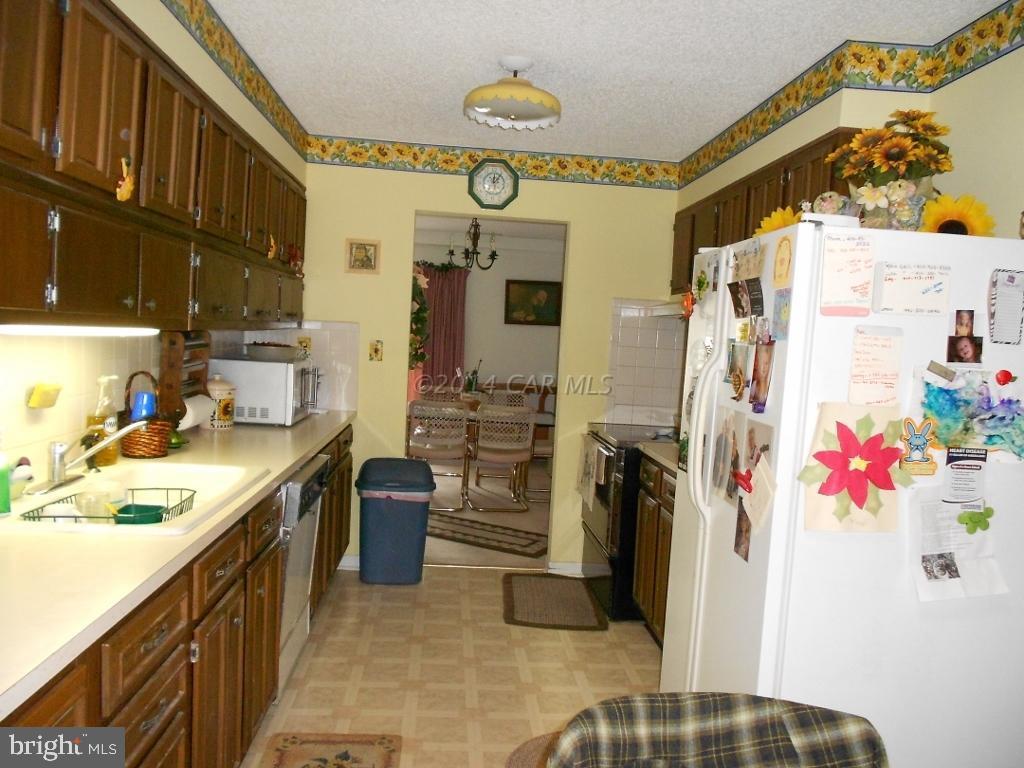 9240 Croppers Island Road Newark, MD 21841 - Photo 7 of 19 a kitchen with a refrigerator and a sink