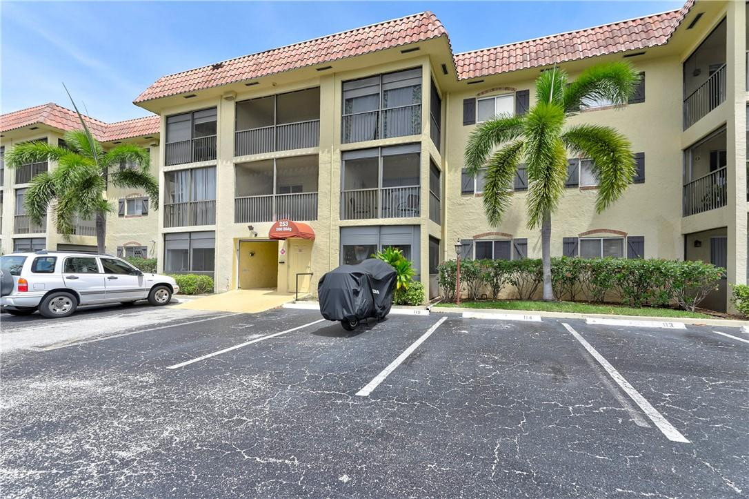 253 South Cypress Road, Unit 246 Pompano Beach, FL 33060 - Photo 14 of 33 a view of a car parked front of a building