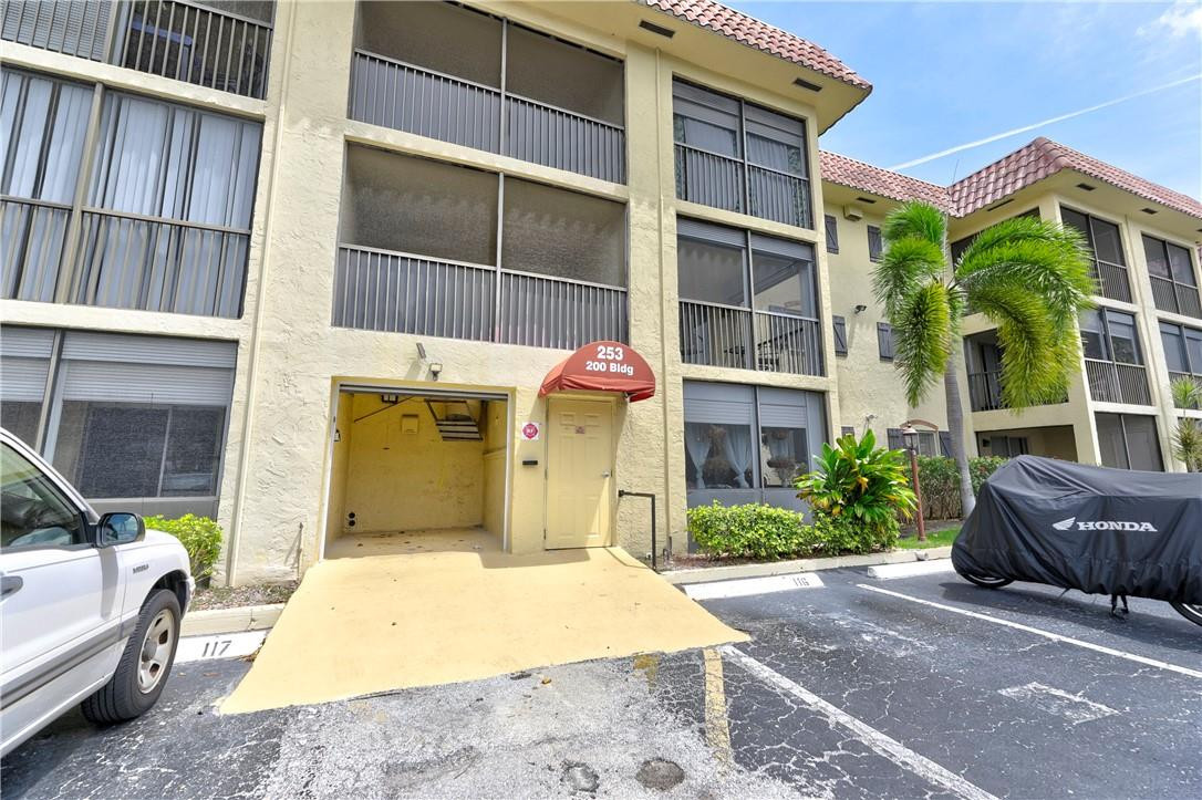 253 South Cypress Road, Unit 246 Pompano Beach, FL 33060 - Photo 15 of 33 a front view of a house with a garden
