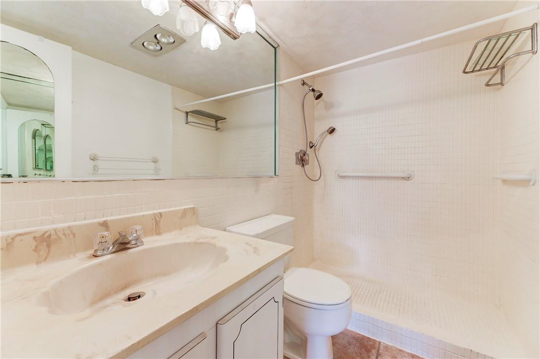 253 South Cypress Road, Unit 246 Pompano Beach, FL 33060 - Photo 25 of 33 a bathroom with a sink toilet and shower