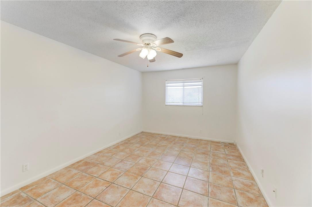 253 South Cypress Road, Unit 246 Pompano Beach, FL 33060 - Photo 28 of 33 an empty room with windows and fan