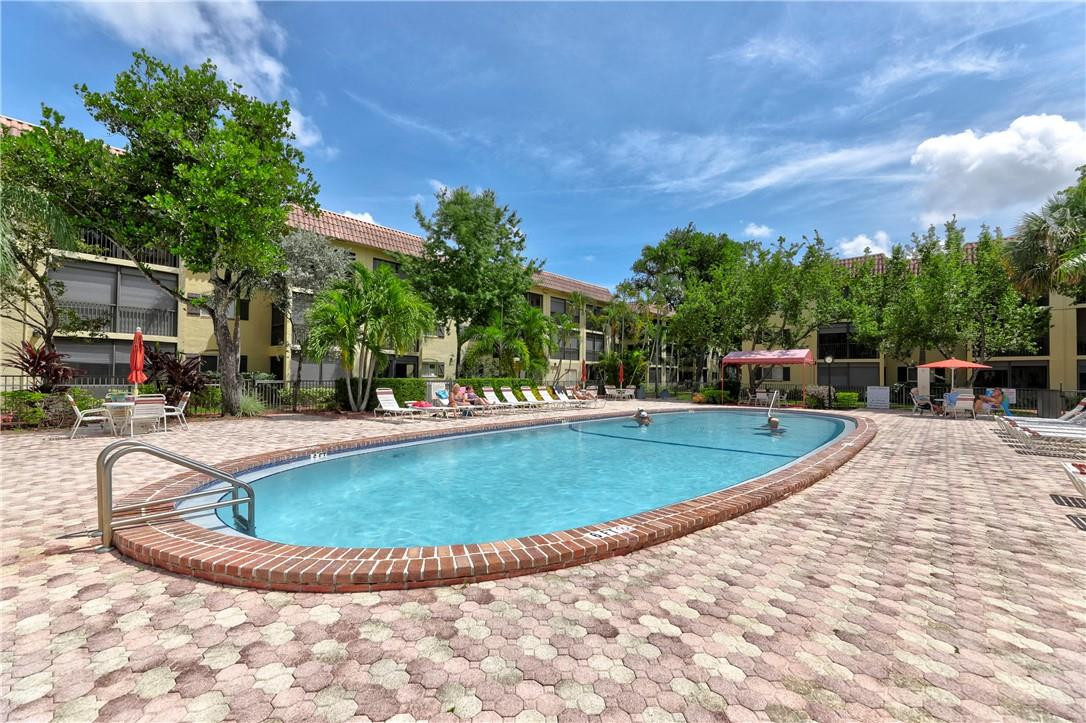 253 South Cypress Road, Unit 246 Pompano Beach, FL 33060 - Photo 10 of 33 a view of outdoor space yard and swimming pool