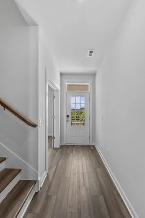 an empty room with a ceiling fan and carpet