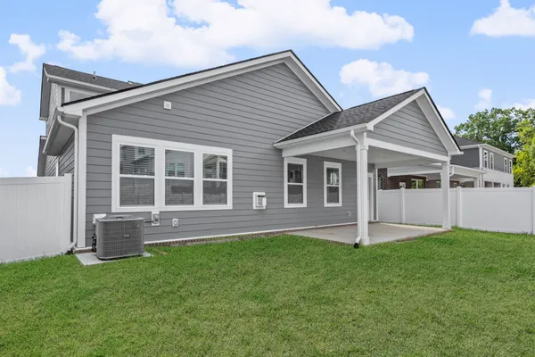 a front view of house with a garden